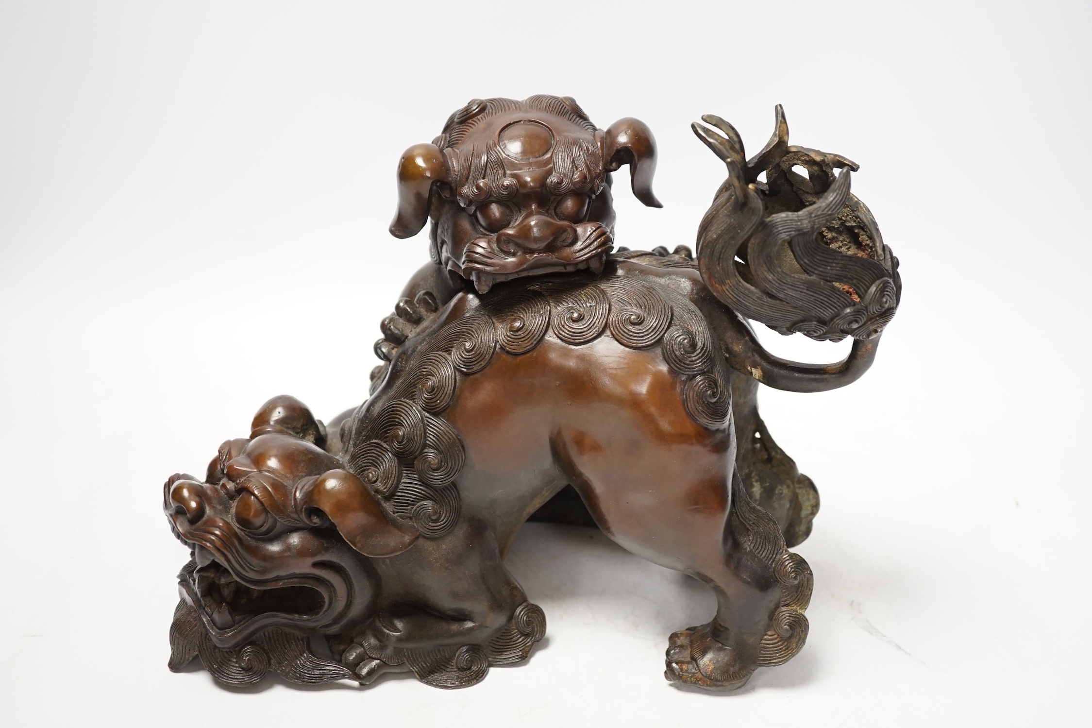 A large Chinese bronze incense burner, modelled as 2 lion dogs playing, 19th century, 22cm high. Condition - good